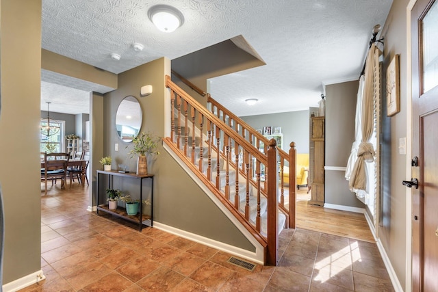369 Highbanks Valley Ct, Newark, OH 43055 - entryway featuring a textured ceiling and stairs