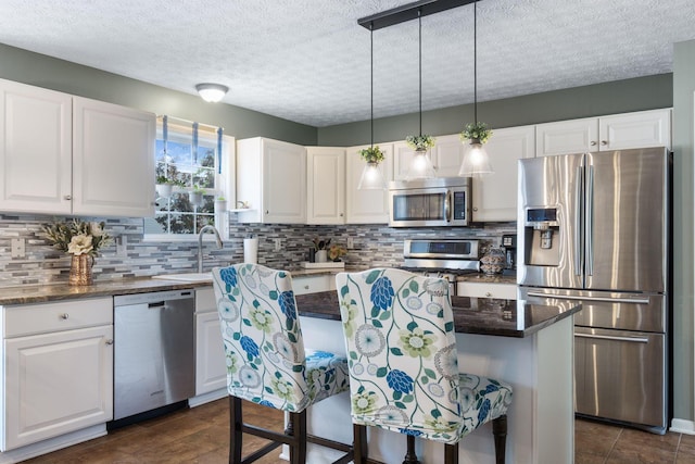 369 Highbanks Valley Ct, Newark, OH 43055 - kitchen with appliances with stainless steel finishes, white cabinetry, decorative backsplash, and a textured ceiling