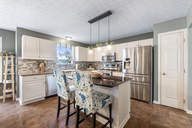 369 Highbanks Valley Ct, Newark, OH 43055 - kitchen featuring appliances with stainless steel finishes, white cabinetry, tasteful backsplash, and a textured ceiling