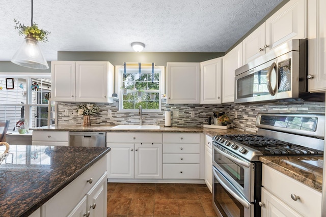 369 Highbanks Valley Ct, Newark, OH 43055 - kitchen with appliances with stainless steel finishes, tasteful backsplash, white cabinets, and pendant lighting