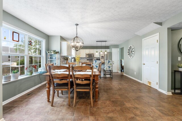369 Highbanks Valley Ct, Newark, OH 43055 - dining area featuring a chandelier and a textured ceiling