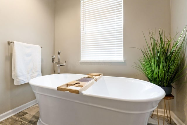 369 Highbanks Valley Ct, Newark, OH 43055 - bathroom featuring a freestanding tub and baseboards