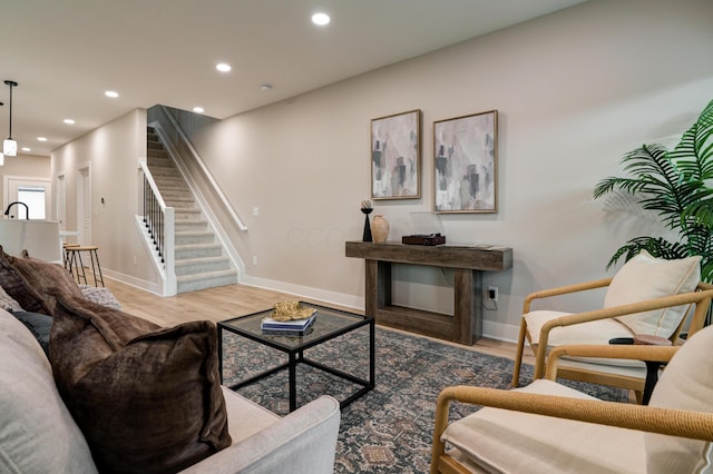 2587 Dayton Ave, Columbus, OH 43202 - living area featuring stairway, wood finished floors, baseboards, and recessed lighting
