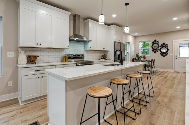 2587 Dayton Ave, Columbus, OH 43202 - kitchen with wall chimney exhaust hood, stainless steel electric range oven, a sink, light wood-style flooring, and recessed lighting