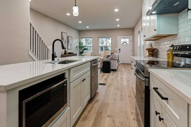 2587 Dayton Ave, Columbus, OH 43202 - kitchen with range hood, electric range oven, a sink, built in microwave, and open floor plan