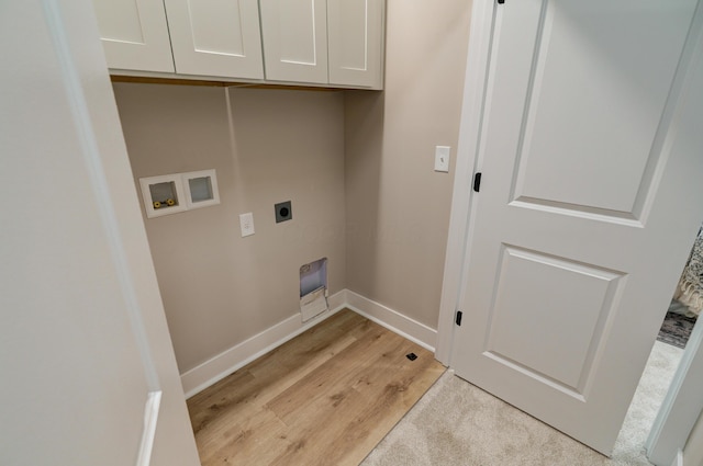 2587 Dayton Ave, Columbus, OH 43202 - laundry area with hookup for an electric dryer, hookup for a washing machine, cabinet space, light wood-style flooring, and baseboards