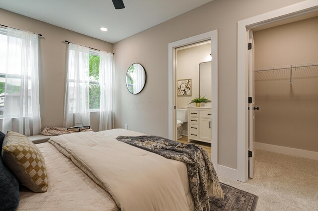 2587 Dayton Ave, Columbus, OH 43202 - bedroom featuring light colored carpet, a spacious closet, ensuite bathroom, baseboards, and a closet