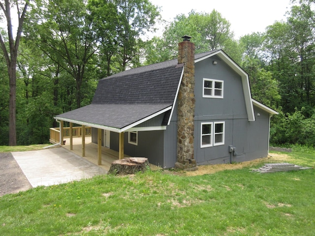 3814 London Hollow Rd NE, Newark, OH 43055 - view of home's exterior with a shingled roof, a yard, a chimney, and driveway