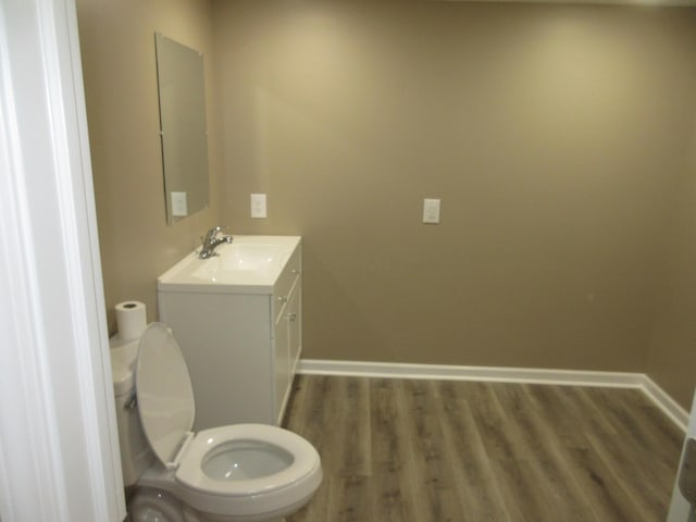 3814 London Hollow Rd NE, Newark, OH 43055 - bathroom featuring vanity, wood finished floors, baseboards, and toilet