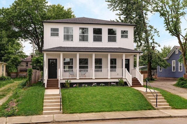2589 Dayton Ave, Columbus, OH 43202 - american foursquare style home with a porch, stairs, roof with shingles, and a front lawn