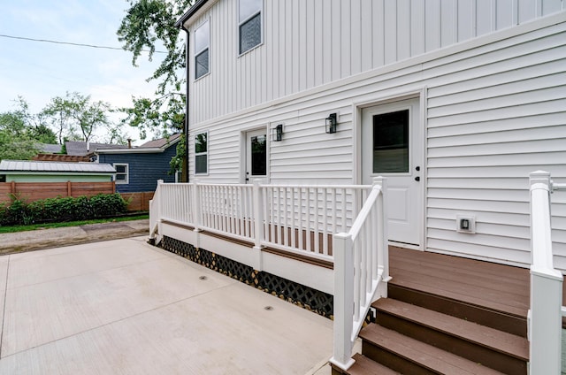 2589 Dayton Ave, Columbus, OH 43202 - entrance to property featuring a patio, a deck, and board and batten siding