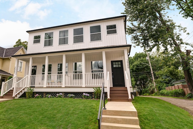 2589 Dayton Ave, Columbus, OH 43202 - view of front of house featuring a porch, a front lawn, and board and batten siding