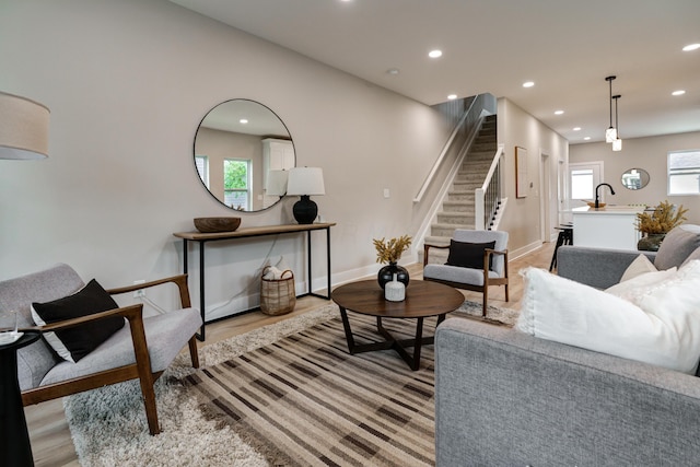 2589 Dayton Ave, Columbus, OH 43202 - living area with stairs, light wood-style floors, recessed lighting, and baseboards