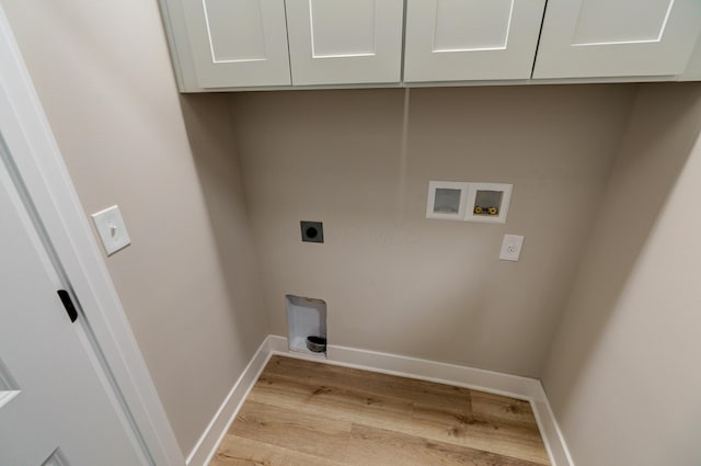 2589 Dayton Ave, Columbus, OH 43202 - laundry area featuring electric dryer hookup, light wood finished floors, cabinet space, washer hookup, and baseboards