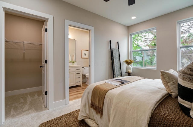 2589 Dayton Ave, Columbus, OH 43202 - bedroom featuring light colored carpet, a walk in closet, baseboards, ensuite bathroom, and recessed lighting