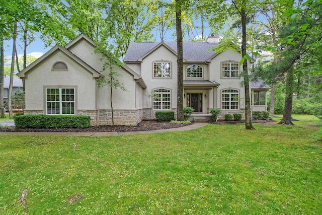 364 Morgan Ln, Columbus, OH 43230 - view of front of house featuring stucco siding, a front lawn, and stone siding