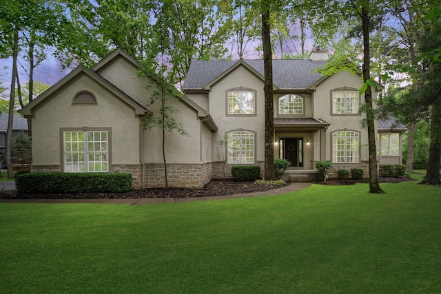 364 Morgan Ln, Columbus, OH 43230 - view of front facade featuring stucco siding, a front lawn, and stone siding