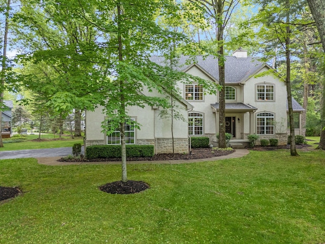 364 Morgan Ln, Columbus, OH 43230 - view of front of property with stone siding, stucco siding, and a front yard