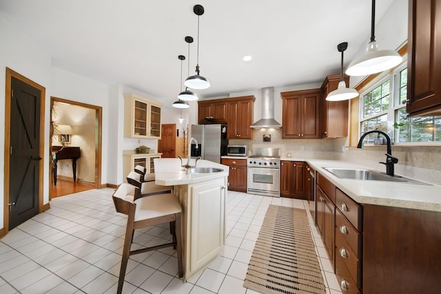 364 Morgan Ln, Columbus, OH 43230 - kitchen featuring appliances with stainless steel finishes, wall chimney exhaust hood, a sink, and light countertops