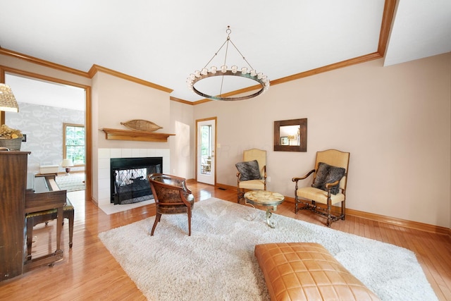 364 Morgan Ln, Columbus, OH 43230 - living room featuring crown molding, light wood-type flooring, baseboards, healthy amount of natural light, and a tiled fireplace