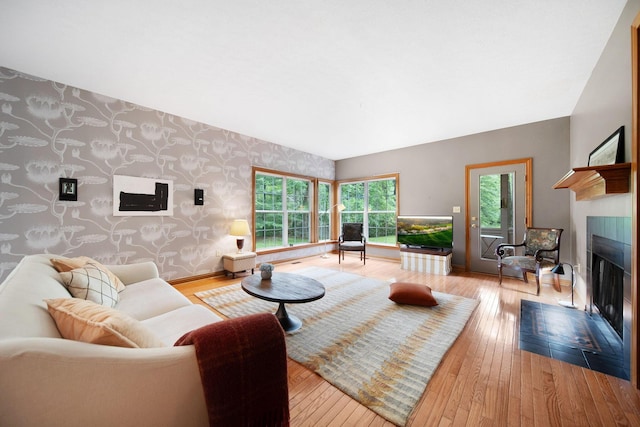 364 Morgan Ln, Columbus, OH 43230 - living room featuring wallpapered walls, a fireplace with flush hearth, hardwood / wood-style flooring, baseboards, and an accent wall