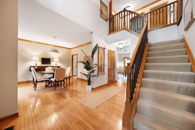 364 Morgan Ln, Columbus, OH 43230 - stairs with baseboards, wood-type flooring, and crown molding