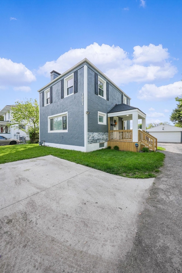 1081 Harrisburg Pike, Columbus, OH 43223 - view of side of home featuring a lawn and stucco siding