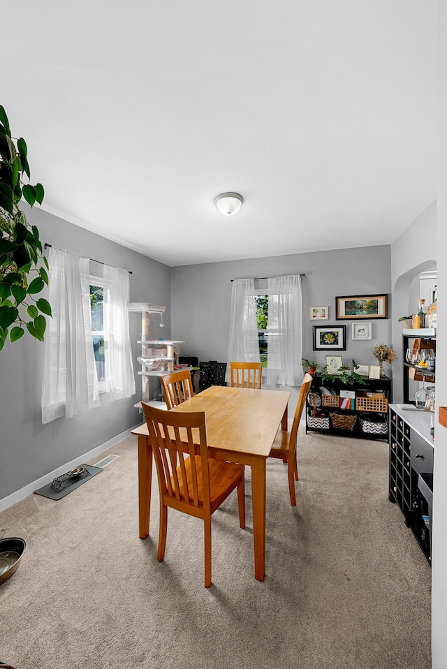 1081 Harrisburg Pike, Columbus, OH 43223 - carpeted dining room featuring healthy amount of natural light and arched walkways