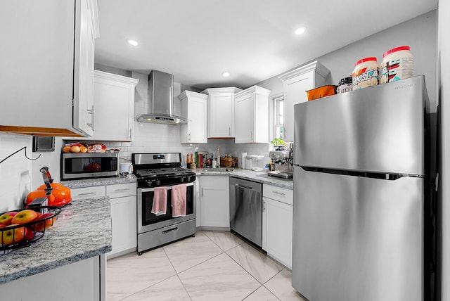 1081 Harrisburg Pike, Columbus, OH 43223 - kitchen with stainless steel appliances, wall chimney exhaust hood, light marble finish flooring, white cabinetry, and tasteful backsplash