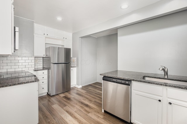 2845 Homecroft Dr, Columbus, OH 43211 - kitchen with stainless steel appliances, a sink, dark stone countertops, white cabinetry, and recessed lighting