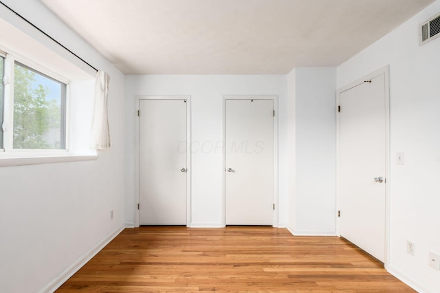 1824 Willoway Cir S, Columbus, OH 43220 - unfurnished bedroom featuring light wood finished floors, multiple closets, and baseboards