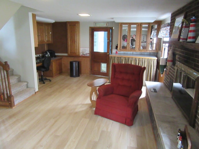 302 W Hubert Ave, Lancaster, OH 43130 - living area featuring a fireplace, light wood-style floors, an office area, and stairs