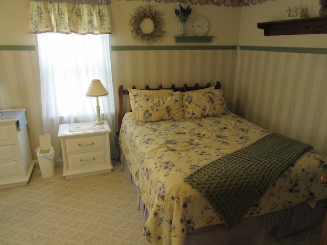 302 W Hubert Ave, Lancaster, OH 43130 - bedroom with wallpapered walls, wainscoting, and light carpet