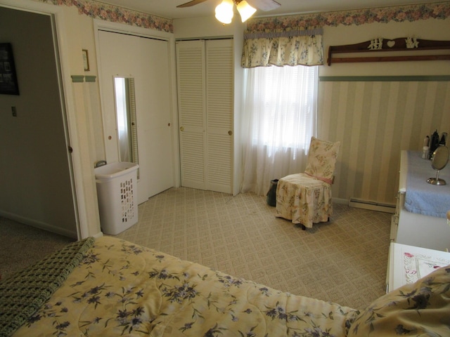 302 W Hubert Ave, Lancaster, OH 43130 - bedroom with a baseboard radiator, carpet, two closets, and ceiling fan