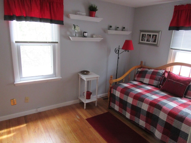 302 W Hubert Ave, Lancaster, OH 43130 - bedroom featuring multiple windows, light wood finished floors, and baseboards