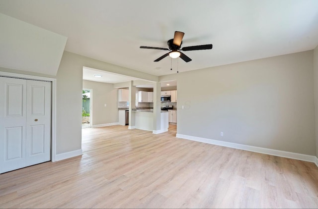 202 Toland St, London, OH 43140 - unfurnished living room with a ceiling fan, light wood-style flooring, and baseboards