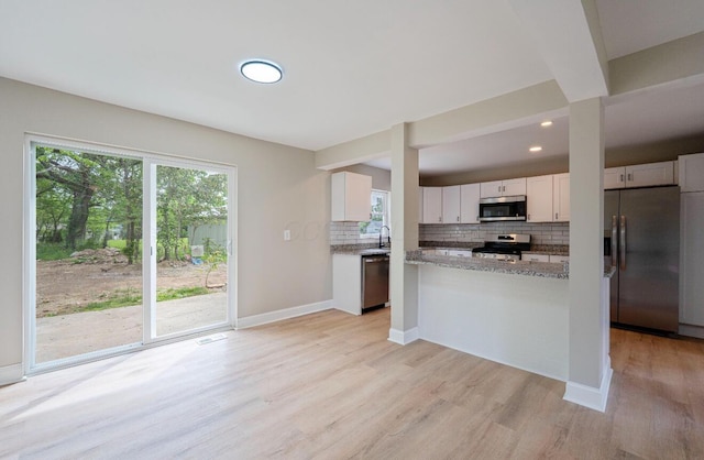 202 Toland St, London, OH 43140 - kitchen with stainless steel appliances, backsplash, light wood finished floors, white cabinets, and a sink
