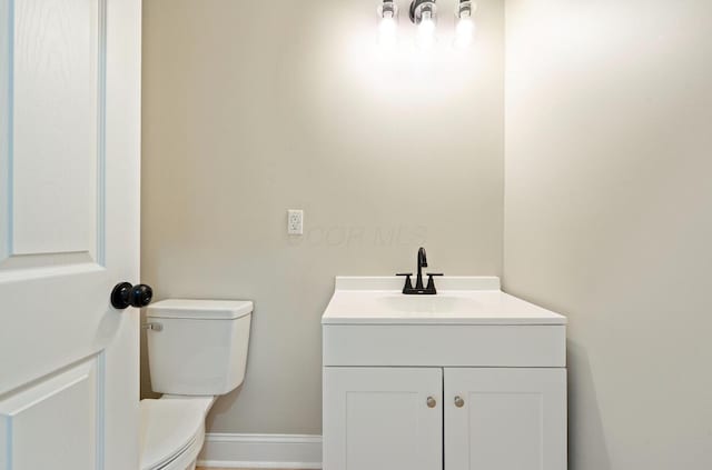 202 Toland St, London, OH 43140 - half bathroom featuring vanity, toilet, and baseboards