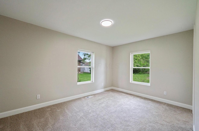 202 Toland St, London, OH 43140 - spare room with baseboards, healthy amount of natural light, and carpet floors