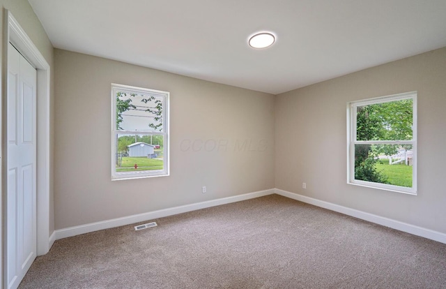 202 Toland St, London, OH 43140 - unfurnished bedroom with carpet, multiple windows, and baseboards