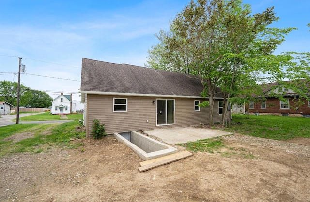202 Toland St, London, OH 43140 - rear view of house with a shingled roof, a patio area, and a lawn