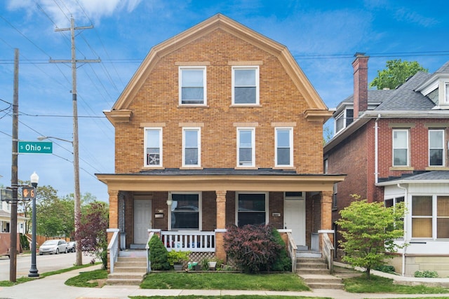 438-440 S Ohio Ave, Columbus, OH 43205 - colonial inspired home with brick siding, covered porch, and a gambrel roof