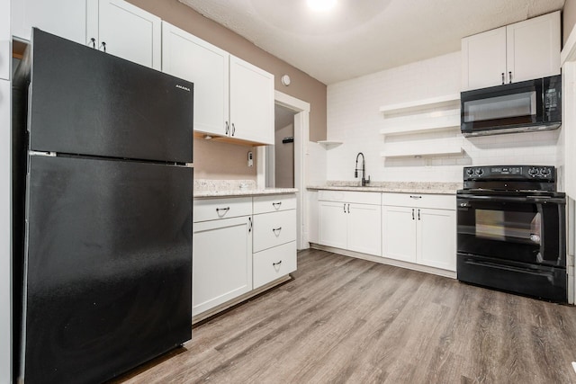 438-440 S Ohio Ave, Columbus, OH 43205 - kitchen with black appliances, a sink, open shelves, light wood-type flooring, and white cabinetry