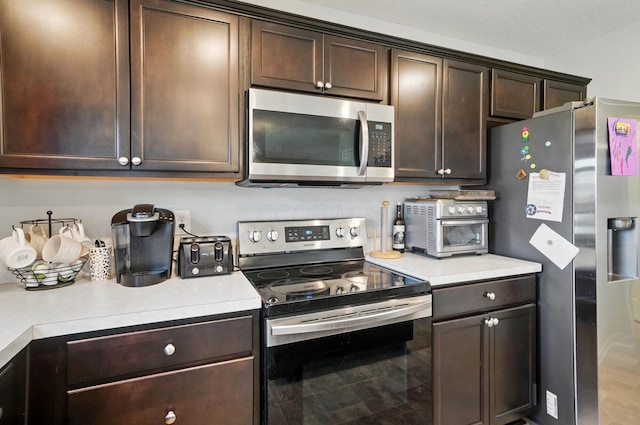 5416 Branchville Dr, Canal Winchester, OH 43110 - kitchen featuring stainless steel appliances, light countertops, and dark brown cabinets