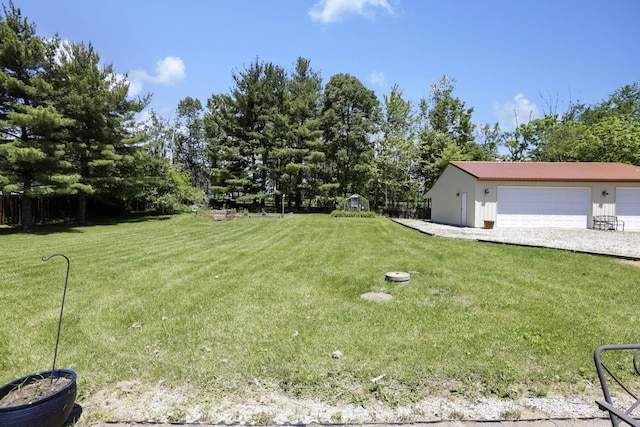 170 Ginder Rd NE, Lancaster, OH 43130 - view of grassy yard featuring a detached garage and an outbuilding