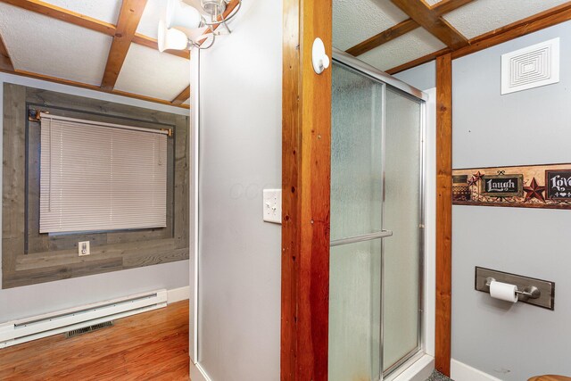 14552 Snyder Rd, Richwood, OH 43344 - full bath with baseboards, a shower with door, wood finished floors, and a baseboard heating unit