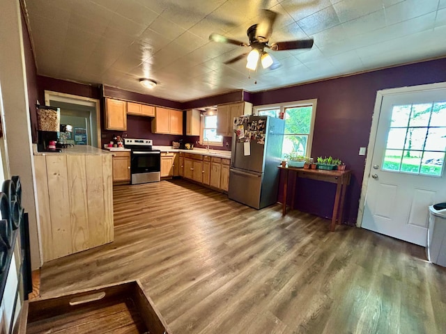 10070 Wolfe Rd, New Vienna, OH 45159 - kitchen with appliances with stainless steel finishes, a sink, light countertops, wood finished floors, and a ceiling fan