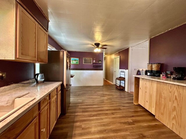 10070 Wolfe Rd, New Vienna, OH 45159 - kitchen with ceiling fan, wood finished floors, light countertops, freestanding refrigerator, and brown cabinetry