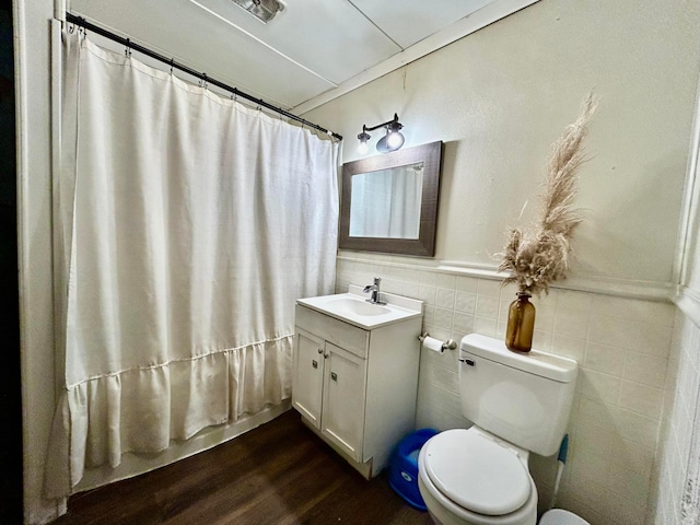 10070 Wolfe Rd, New Vienna, OH 45159 - full bath with toilet, wood finished floors, vanity, tile walls, and a shower with shower curtain