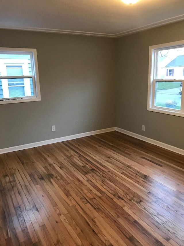 2649 Hiawatha St, Columbus, OH 43211 - empty room featuring dark wood-type flooring, baseboards, and ornamental molding